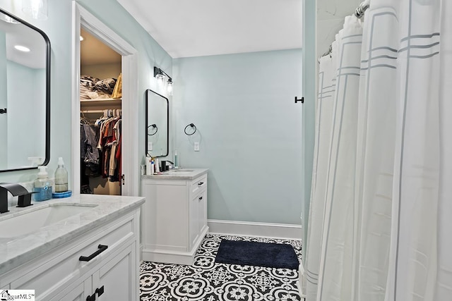 501 N Adair St, Clinton, SC 29325 - full bathroom featuring a spacious closet, tile patterned floors, a sink, baseboards, and two vanities