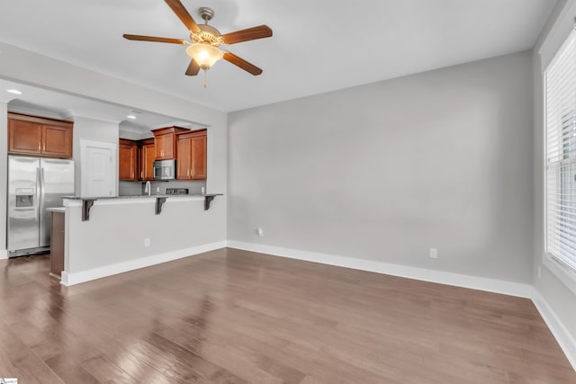 620 Springbank Aly, Greer, SC 29651 - unfurnished living room featuring a wealth of natural light, baseboards, ceiling fan, and dark wood-type flooring
