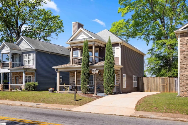 504 Anderson St, Greenville, SC 29601 - view of front facade with a porch, a chimney, fence, a balcony, and a front yard