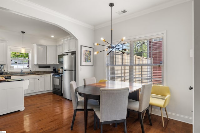 504 Anderson St, Greenville, SC 29601 - dining space with arched walkways, dark wood-style flooring, visible vents, and plenty of natural light