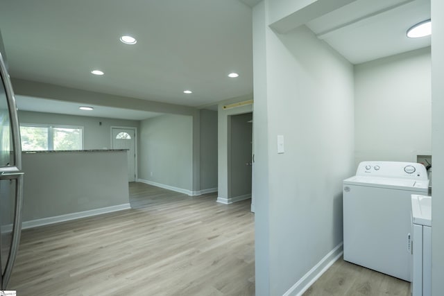 laundry area featuring light wood-style flooring, baseboards, recessed lighting, laundry area, and washer / dryer