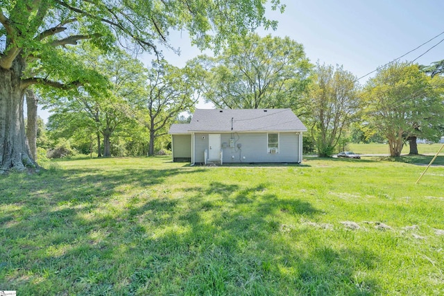 back of house featuring a yard
