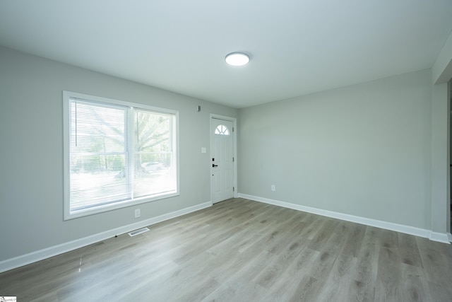 interior space featuring light wood-style flooring, visible vents, and baseboards