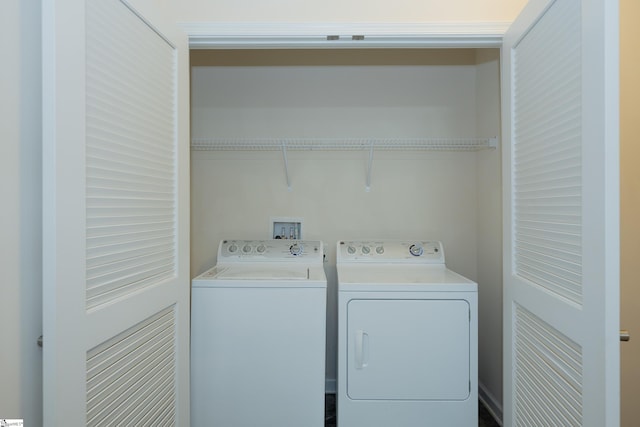 clothes washing area featuring washer and dryer and laundry area