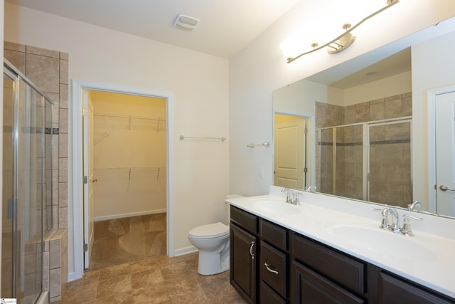 bathroom featuring a sink, double vanity, and a stall shower