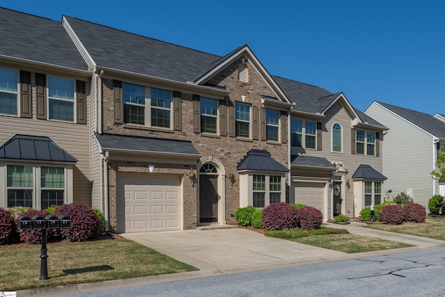 multi unit property featuring brick siding, an attached garage, and driveway