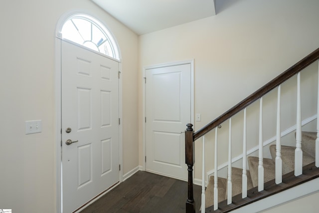 foyer with stairs and dark wood-style floors