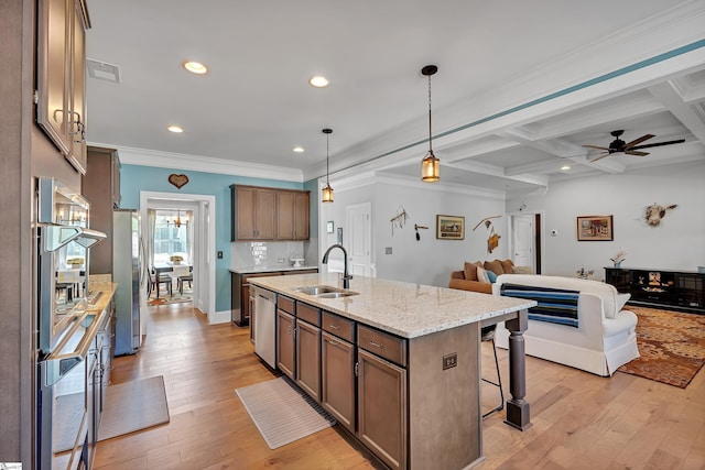 kitchen featuring a sink, open floor plan, a breakfast bar area, appliances with stainless steel finishes, and visible vents