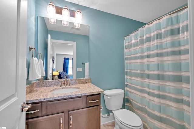 bathroom featuring visible vents, toilet, and vanity