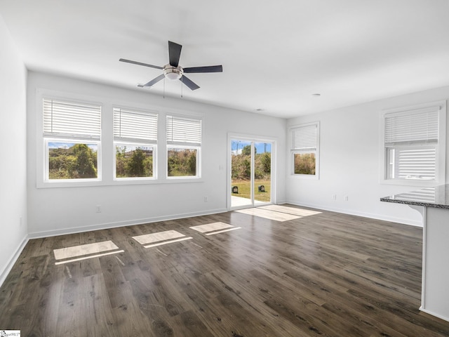 1415 Darrowby Way, Spartanburg, SC 29301 - unfurnished living room featuring baseboards, a ceiling fan, and dark wood-type flooring