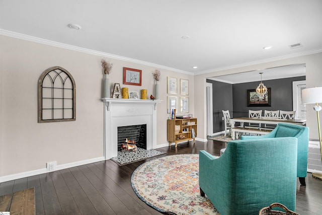 204 Thackston St, Fountain Inn, SC 29644 - living area featuring a warm lit fireplace, wood finished floors, visible vents, ornamental molding, and baseboards
