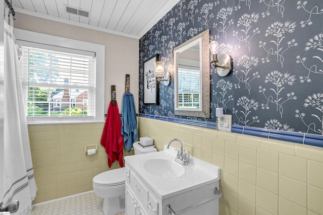 204 Thackston St, Fountain Inn, SC 29644 - bathroom with wainscoting, toilet, vanity, and tile walls