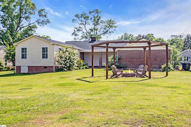 204 Thackston St, Fountain Inn, SC 29644 - back of house featuring crawl space, a fire pit, and a yard