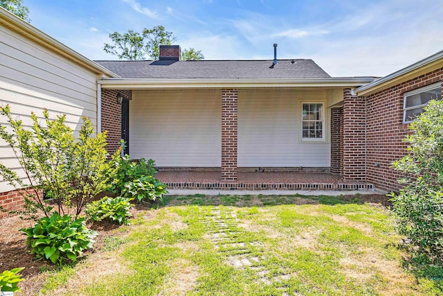 204 Thackston St, Fountain Inn, SC 29644 - rear view of property featuring brick siding, a lawn, and a chimney