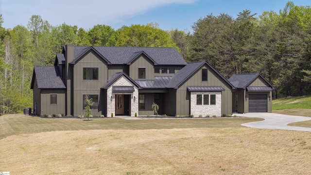 545 E Airport Rd, Greer, SC 29651 - modern inspired farmhouse featuring a standing seam roof, driveway, metal roof, board and batten siding, and a front yard