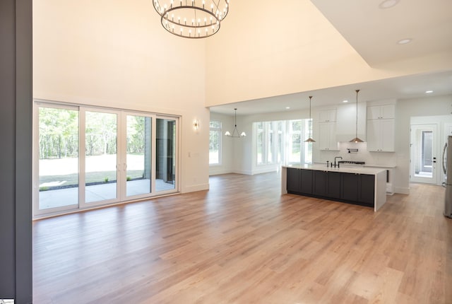 545 E Airport Rd, Greer, SC 29651 - kitchen with a chandelier, light countertops, white cabinets, and open floor plan
