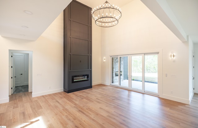 545 E Airport Rd, Greer, SC 29651 - unfurnished living room featuring a high ceiling, a notable chandelier, and baseboards