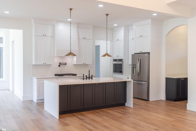 545 E Airport Rd, Greer, SC 29651 - kitchen with light wood finished floors, white cabinets, arched walkways, and appliances with stainless steel finishes
