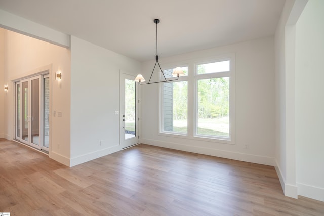 545 E Airport Rd, Greer, SC 29651 - unfurnished dining area featuring baseboards, light wood-style floors, and a notable chandelier