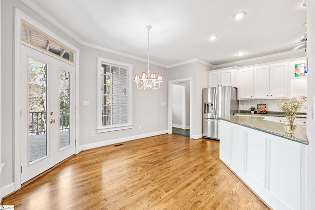 8 Atchison Way, Simpsonville, SC 29680 - kitchen with light wood-style flooring, an inviting chandelier, ornamental molding, and stainless steel fridge with ice dispenser