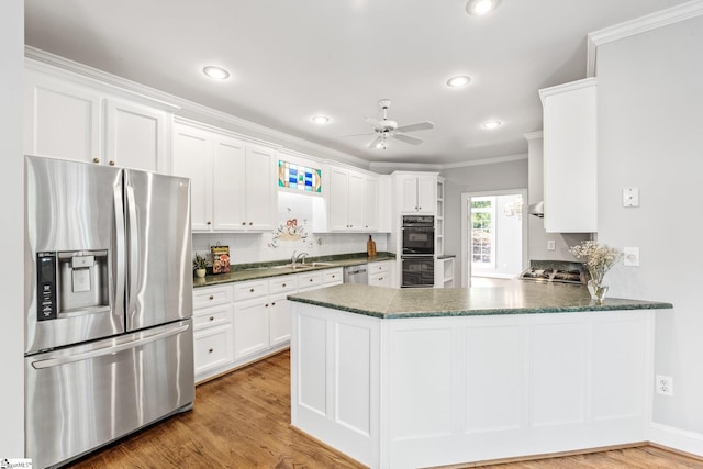 8 Atchison Way, Simpsonville, SC 29680 - kitchen featuring ceiling fan, appliances with stainless steel finishes, white cabinetry, a peninsula, and ornamental molding