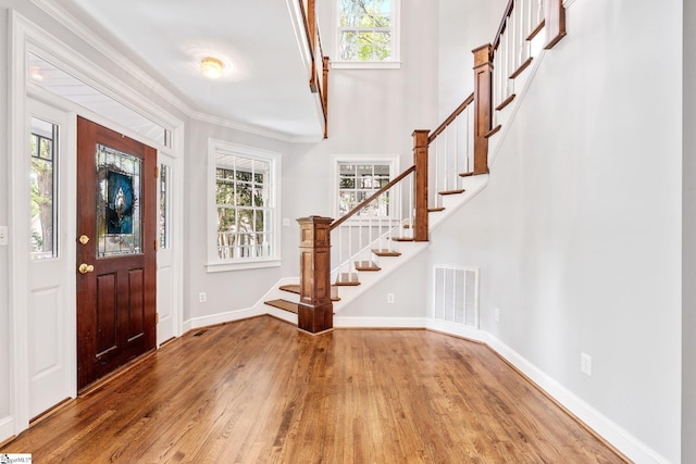 8 Atchison Way, Simpsonville, SC 29680 - foyer entrance featuring wood finished floors, visible vents, stairs, and a wealth of natural light