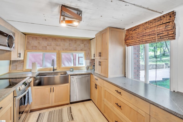 1506 W Lakeshore Dr, Landrum, SC 29356 - kitchen with stainless steel appliances, light brown cabinetry, a sink, and backsplash