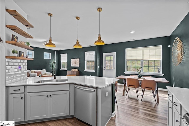 633 Morning Meadows Dr, Inman, SC 29349 - kitchen featuring light countertops, wood finished floors, stainless steel dishwasher, a sink, and decorative light fixtures