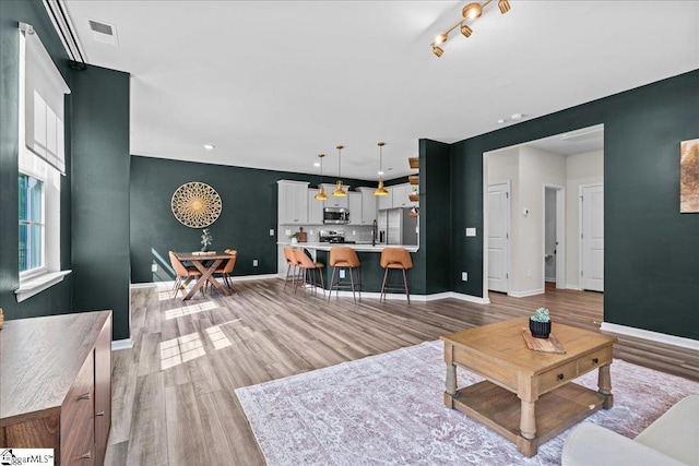 633 Morning Meadows Dr, Inman, SC 29349 - living room featuring visible vents, light wood finished floors, and baseboards