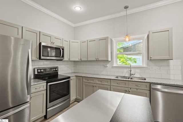 kitchen with stainless steel appliances, a sink, backsplash, and crown molding
