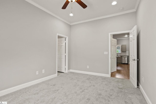 unfurnished bedroom featuring baseboards, carpet flooring, recessed lighting, and crown molding