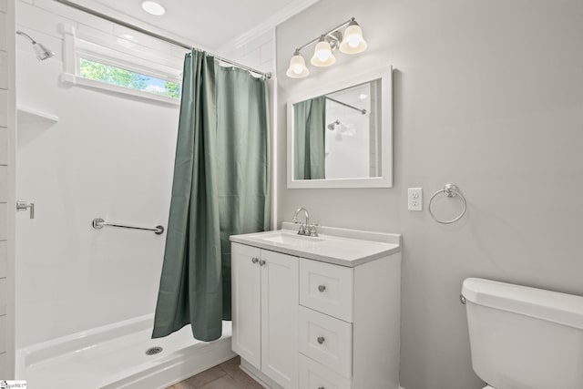 bathroom with vanity, a shower stall, and toilet