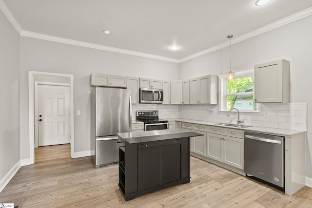 kitchen with ornamental molding, a sink, backsplash, and appliances with stainless steel finishes