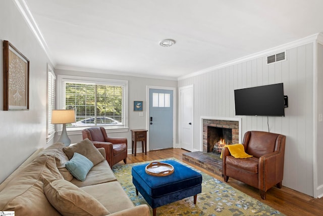 210 Keith Dr, Greenville, SC 29607 - living room featuring crown molding, wood finished floors, baseboards, a brick fireplace, and visible vents