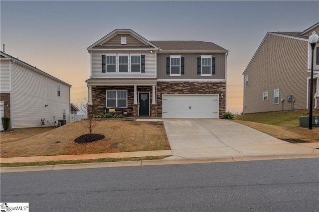136 Light Spring Rd, Easley, SC 29642 - craftsman house featuring a porch, cooling unit, driveway, stone siding, and an attached garage