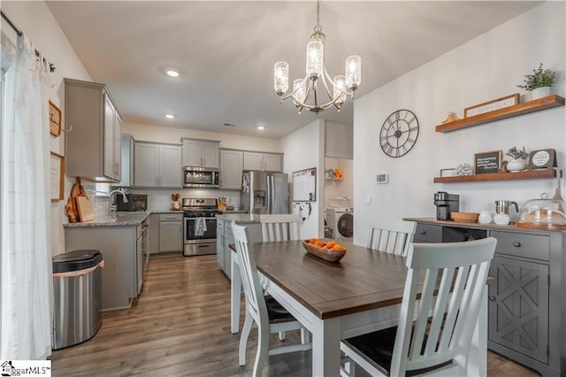 136 Light Spring Rd, Easley, SC 29642 - dining space featuring washer / clothes dryer, recessed lighting, an inviting chandelier, and dark wood-type flooring