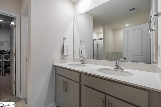136 Light Spring Rd, Easley, SC 29642 - bathroom featuring a walk in closet, visible vents, double vanity, and a sink