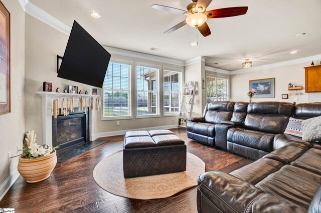 living room featuring baseboards, wood finished floors, visible vents, and plenty of natural light