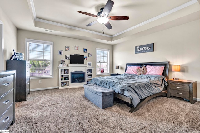 bedroom featuring carpet, crown molding, and a raised ceiling
