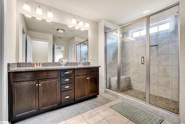full bathroom featuring tile patterned floors, a sink, double vanity, and a stall shower