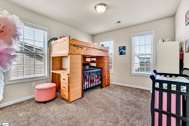 bedroom featuring carpet floors, visible vents, and baseboards