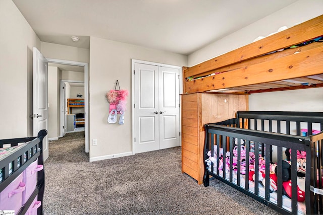 carpeted bedroom featuring a closet and baseboards