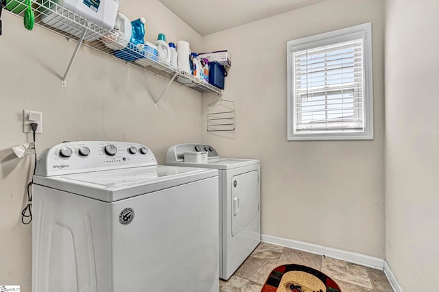 laundry room featuring separate washer and dryer, baseboards, and laundry area