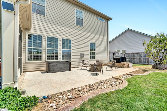 back of house featuring fence, a yard, and a patio