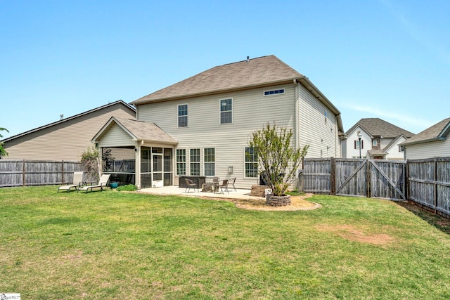 back of house featuring a patio area, a sunroom, a fenced backyard, and a lawn