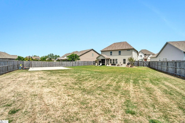 view of yard featuring a patio area and a fenced backyard