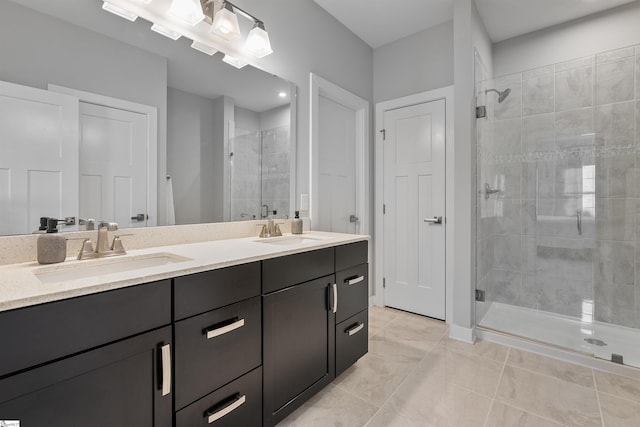 full bathroom featuring a sink, double vanity, and a stall shower