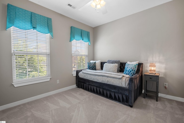 bedroom featuring carpet floors, multiple windows, and visible vents