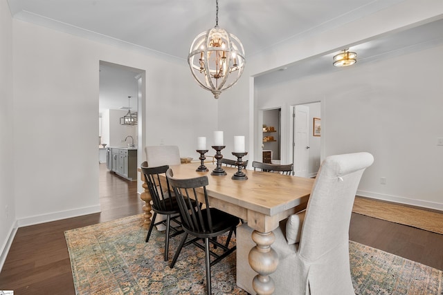 dining space with wood finished floors, baseboards, and a notable chandelier