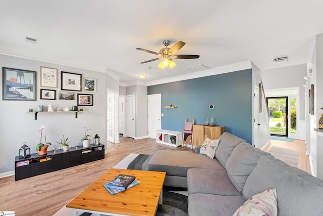 living room featuring crown molding, baseboards, a ceiling fan, and wood finished floors
